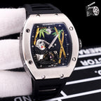 Richard Mille watch with dark rubber strap, stainless case, skeleton dial with green accents.
