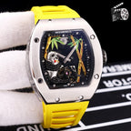 Richard Mille watch with yellow rubber strap, stainless case, skeleton dial with green and gold details.