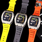 Richard Mille watches on black background with yellow, gray, and orange rubber straps.