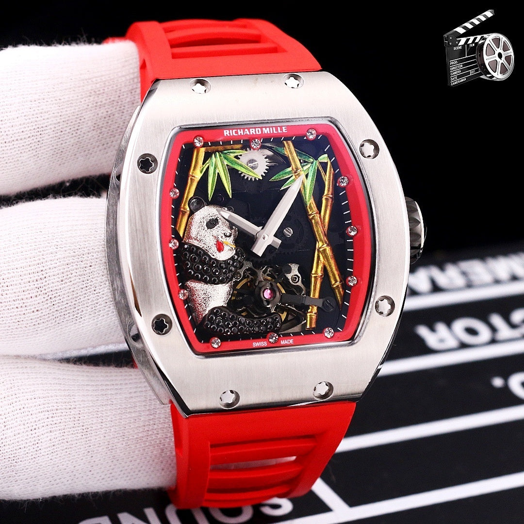 Richard Mille watch with orange rubber strap, stainless case, skeleton dial with green and red border.