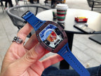 Richard Mille watch with blue strap and dark case, close-up of colorful skeleton dial
