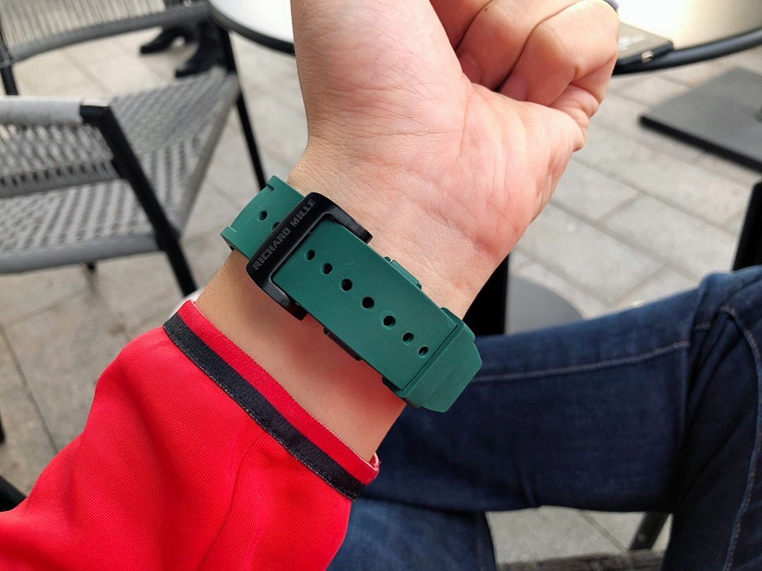 Richard Mille watch with green rubber strap, underside view with pin and holes