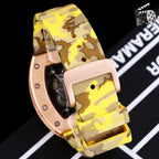 Richard Mille watch with rose-gold case and yellow camouflage strap, side close-up.