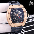 Richard Mille watch with rose-gold case and black silicone strap, skeleton dial.