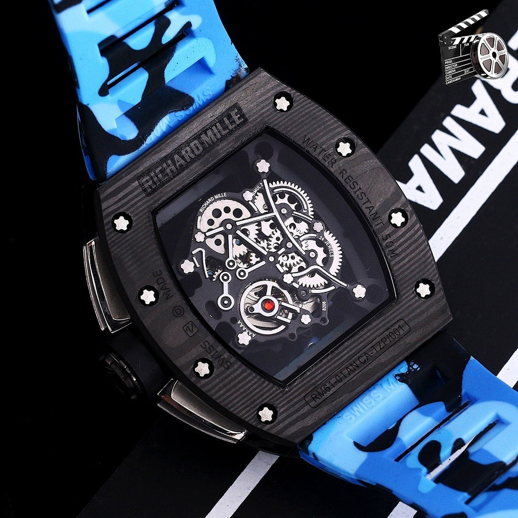 Blue camo strap watch close-up: black case, skeleton dial, visible gearwork.