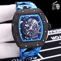 Blue camo rubber strap watch with black case and skeleton dial, visible mechanical gears.
