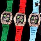 Three Richard Mille watches with green, red, and light blue silicone straps; crystal rose-gold bezels