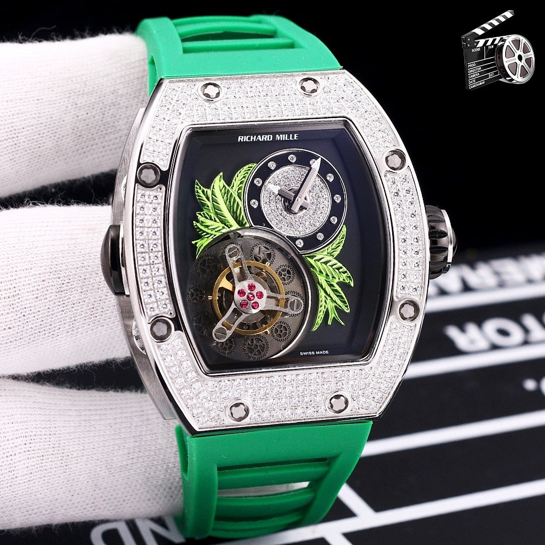 Silver-toned watch with green silicone strap; dark dial with green leaf art and skeleton movement.