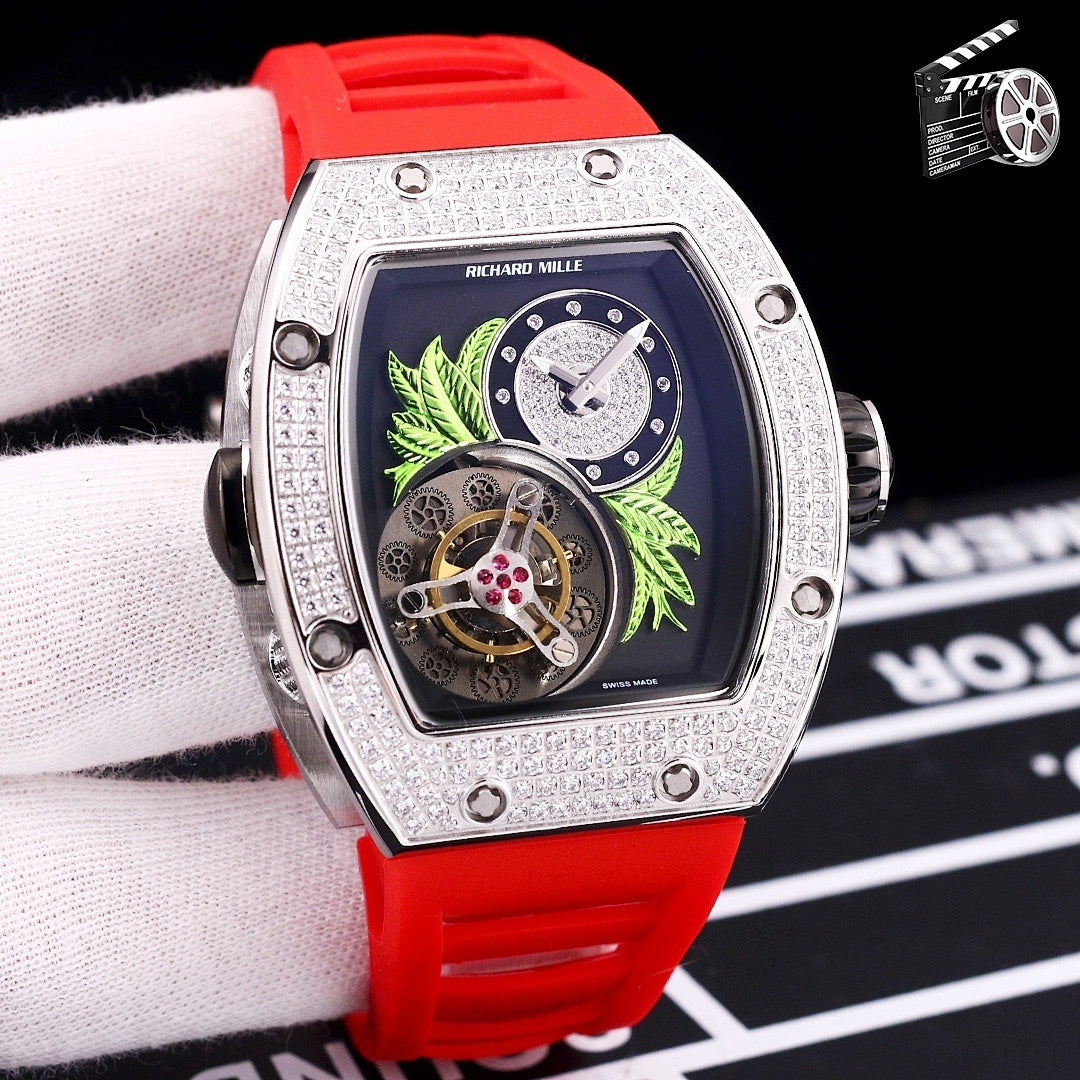 Silver-toned watch with red silicone strap; dark dial with green leaf art and skeleton movement.