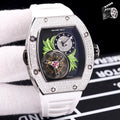Silver-toned watch with white silicone strap; dark dial with green leaf art and skeleton movement.