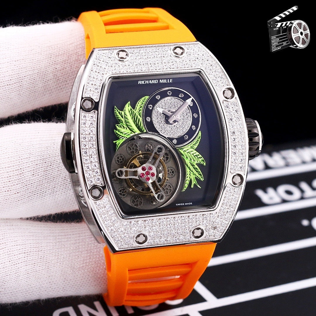 Silver-toned watch with orange silicone strap; dark dial with green leaf art and skeleton movement.