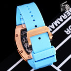 Richard Mille watch with rose-gold case and blue silicone strap, side profile.