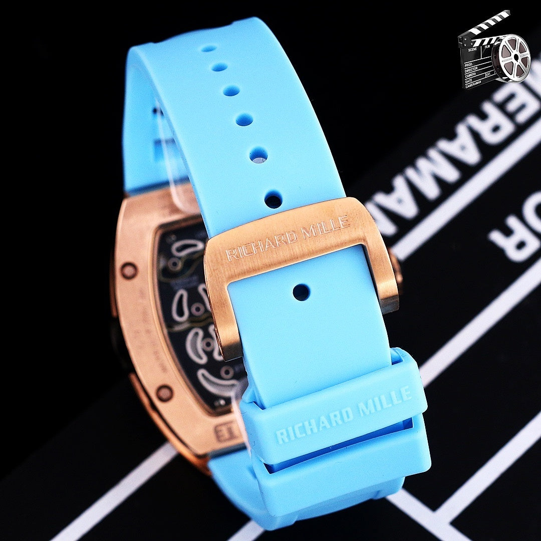 Richard Mille watch with rose-gold case and blue silicone strap, side profile.