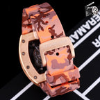 Richard Mille watch with rose gold case and orange-pink camo rubber strap, clasp detail.