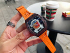 Richard Mille watch with dark brown case and orange rubber strap, colorful dial visible in hand