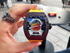 Richard Mille watch with dark brown case, yellow rubber strap, front dial close-up in hand