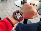 Richard Mille watch on wrist with dark brown case and red rubber strap