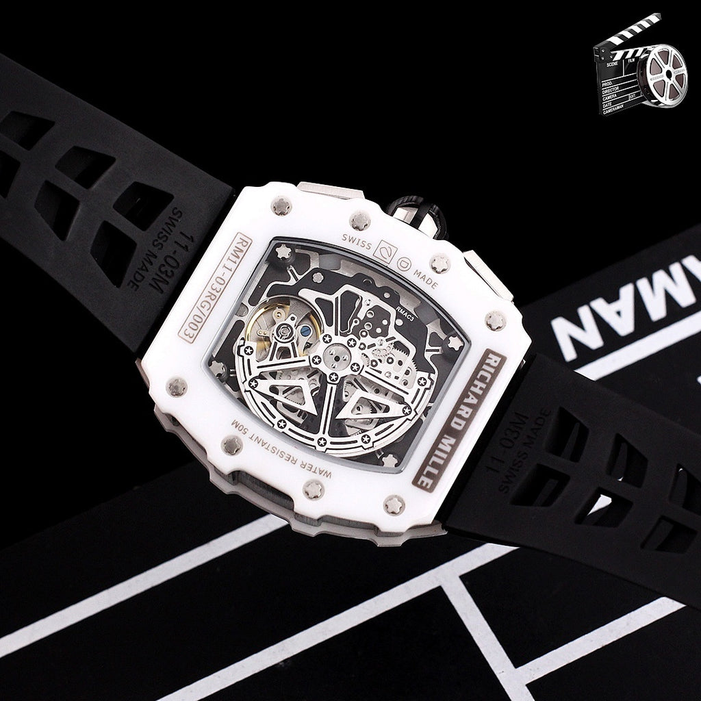 Richard Mille watch caseback, exposed movement on white frame with black silicone strap