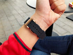 Richard Mille watch with black strap band, strap holes visible on wrist.