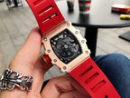 Men’s jeweled skeleton watch with red silicone strap close-up, black dial and screws