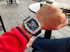 Richard Mille watch on wrist with black strap and silver jeweled case