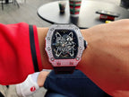 Richard Mille watch on wrist with dark strap and jeweled silver bezel