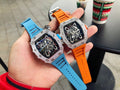 Richard Mille watches with faceted silver bezels, blue and orange rubber straps.