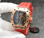 Richard Mille watch with red silicone strap, gold-toned case, skeleton dial view.