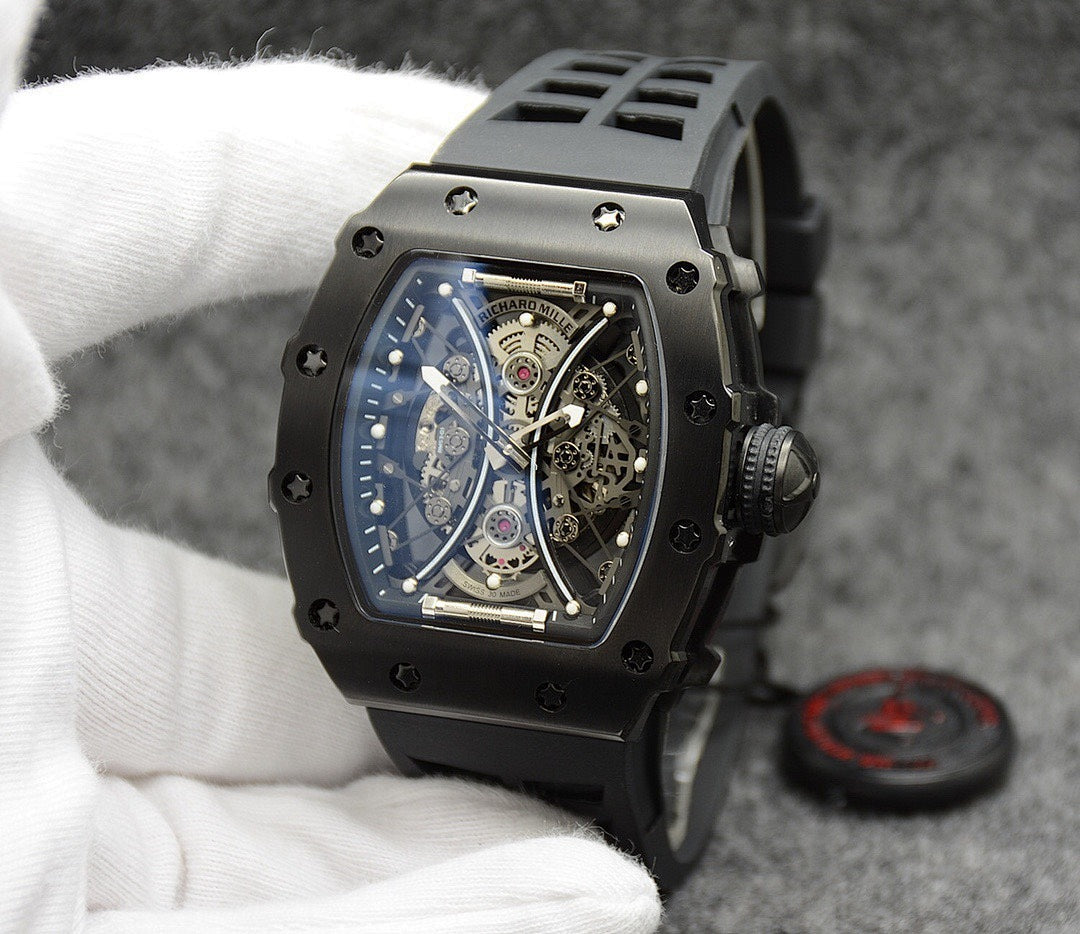 Richard Mille watch with black silicone strap, black case, skeleton dial face.