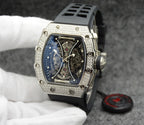 Richard Mille watch with silver jeweled bezel, blue skeleton dial, black rubber strap