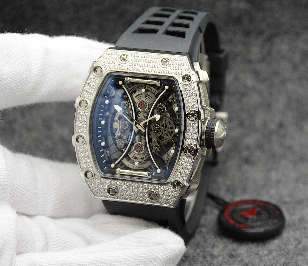 Richard Mille watch with silver jeweled bezel, blue skeleton dial, black rubber strap