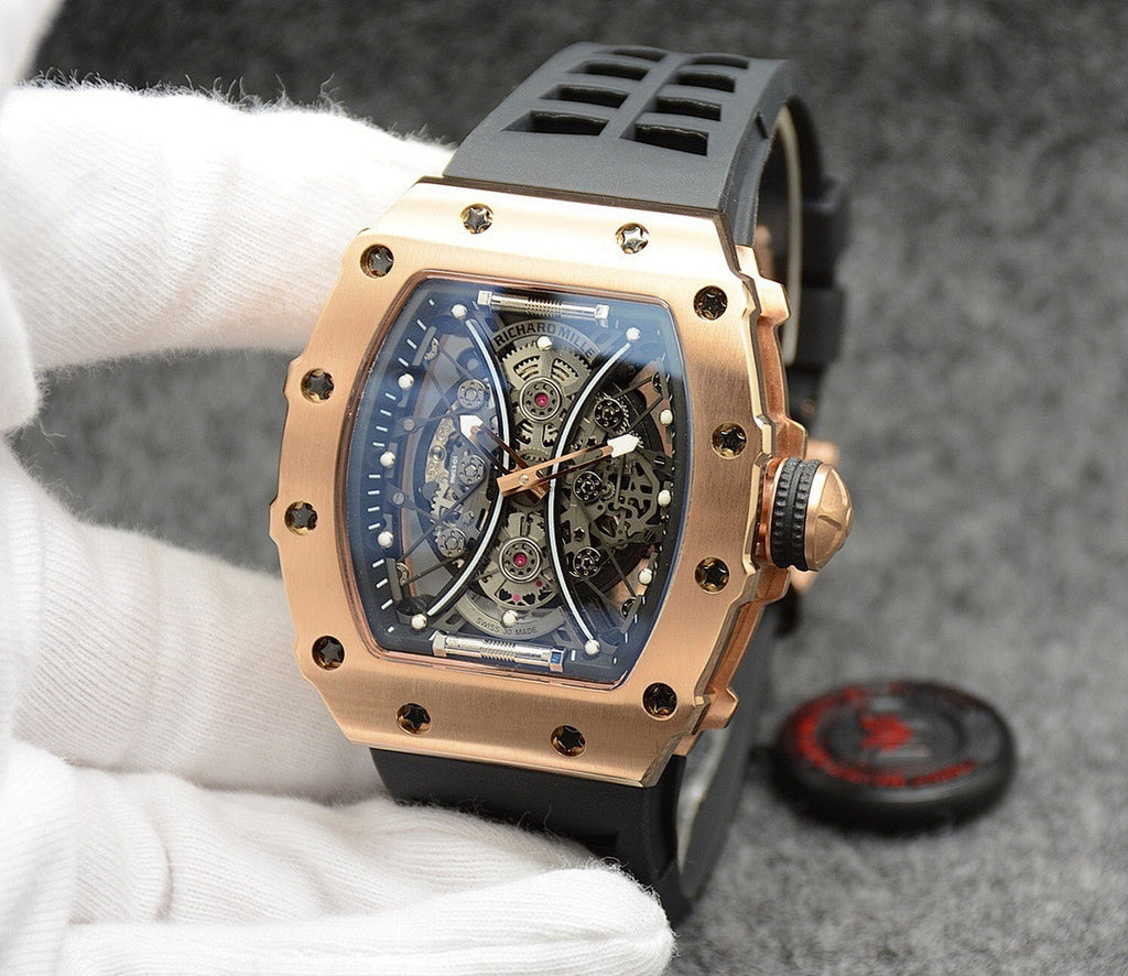 Richard Mille watch with dark strap, gold-toned case, open-work skeleton dial.