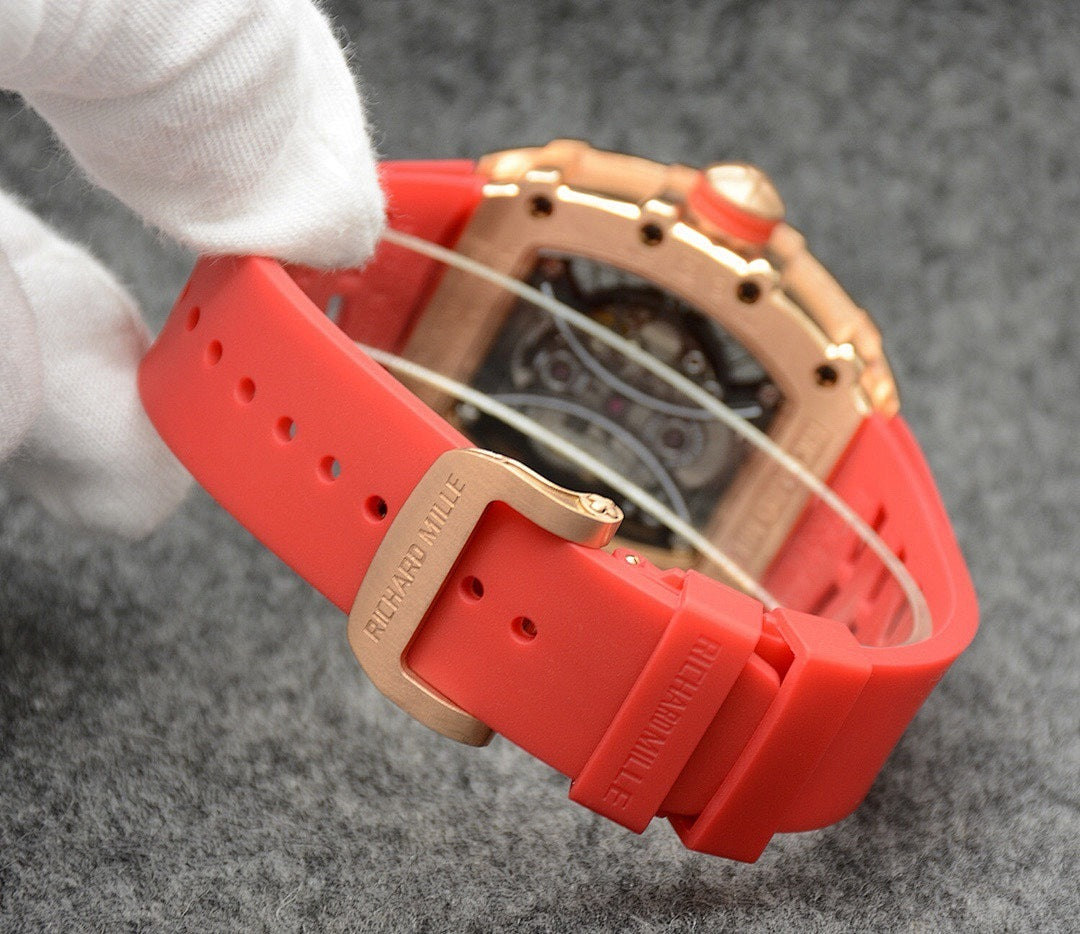 Richard Mille watch with red silicone strap, side view of case and band holes.