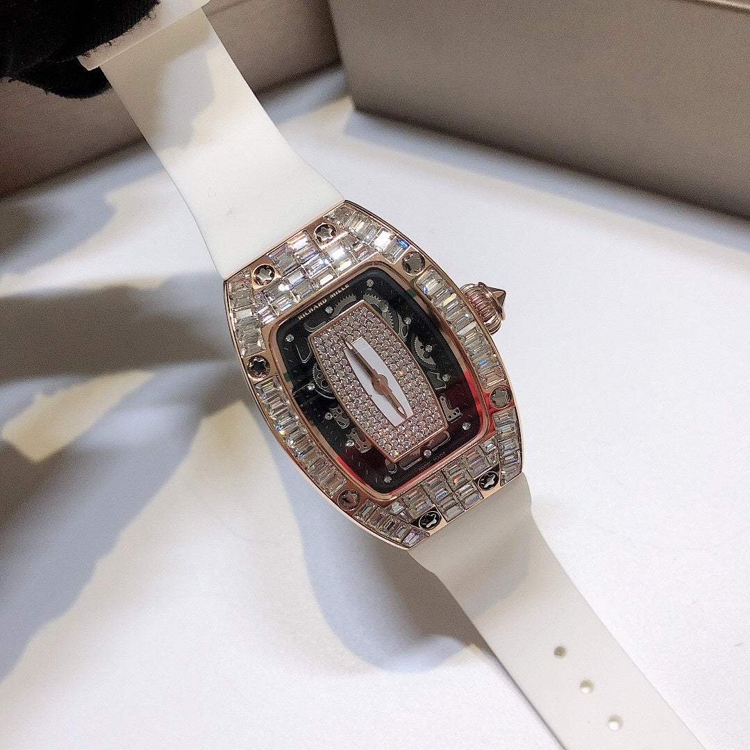 Richard Mille watch with white rubber strap, rose-gold case, and gem-set bezel