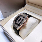 Richard Mille watch displayed on pillow with black rubber strap and rose-gold case