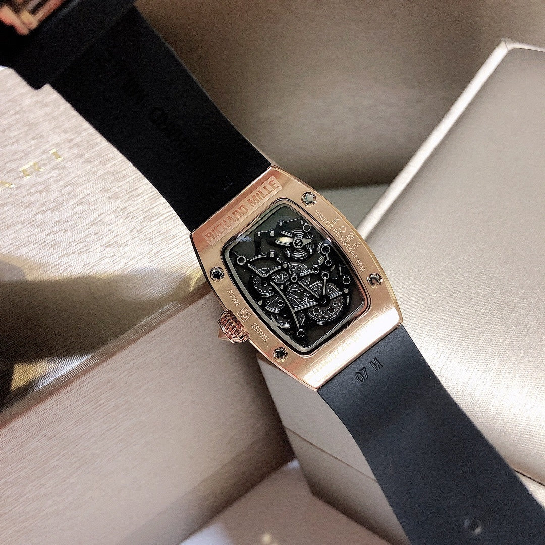 Richard Mille watch with black rubber strap and rose-gold case, skeleton dial visible