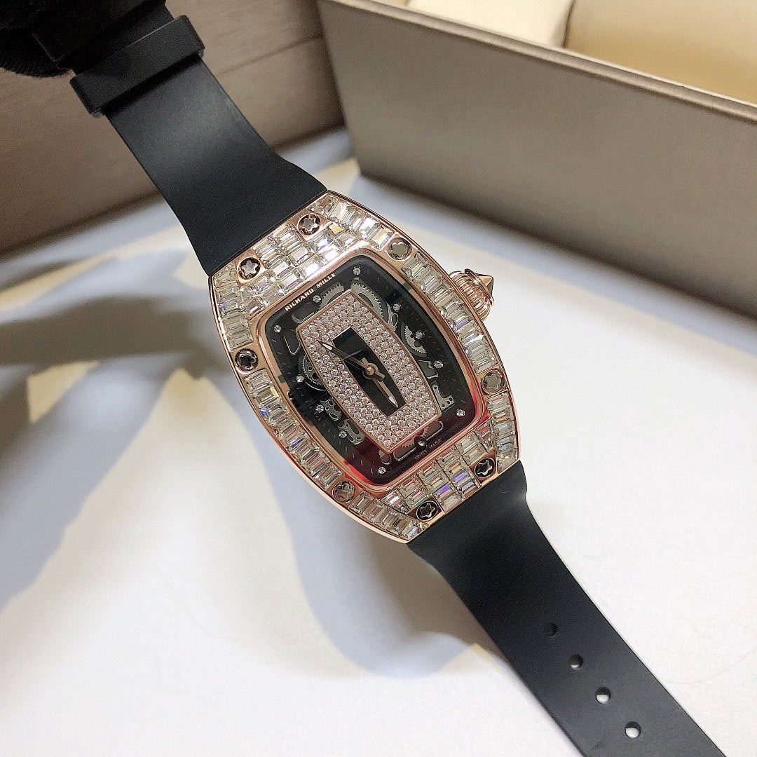 Richard Mille watch with black rubber strap, rose-gold case, and gem-set bezel