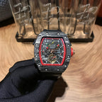 Richard Mille watch with black case, skeleton dial, red bezel, on black strap