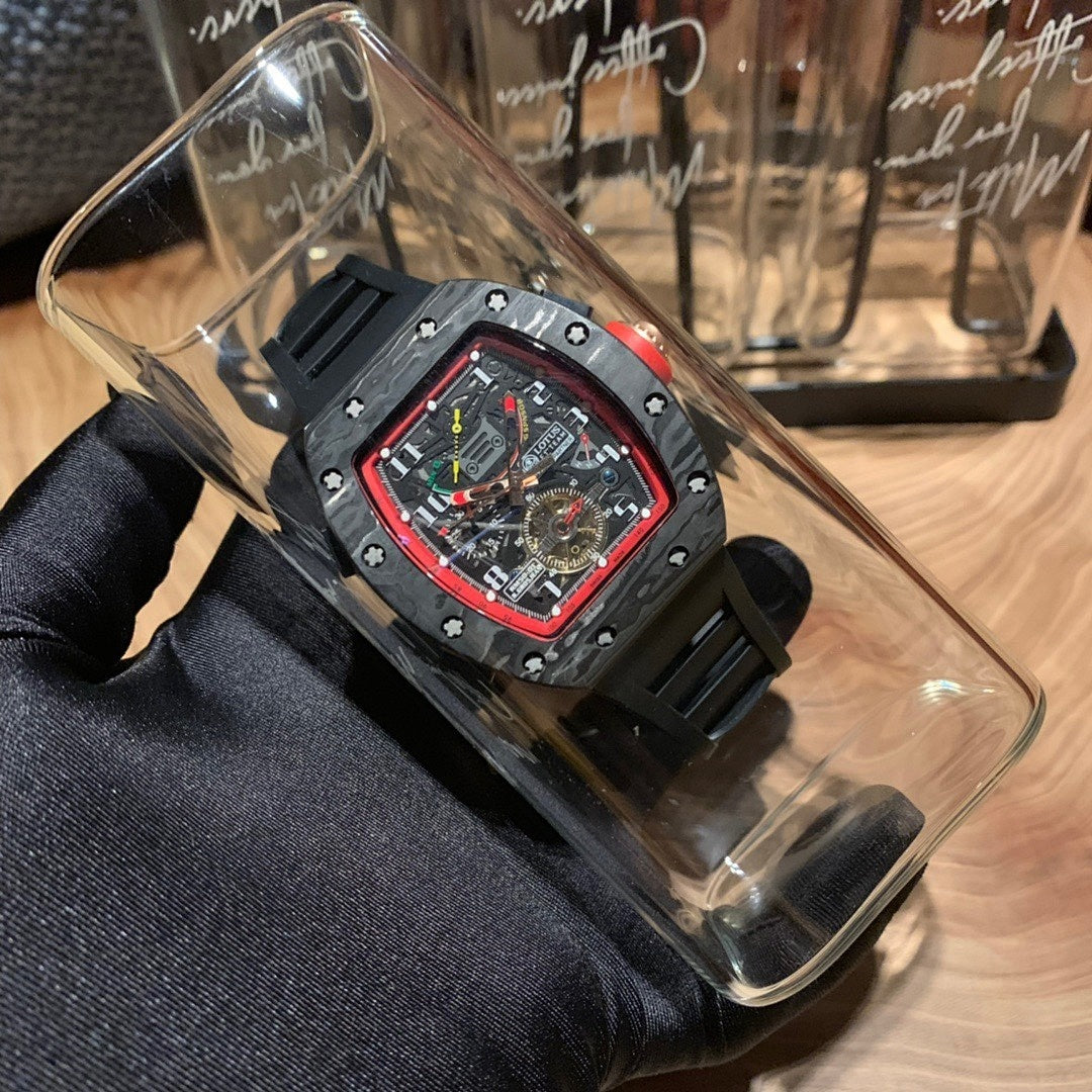 Richard Mille watch in clear display case, black strap, red bezel, skeleton dial