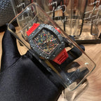 Richard Mille watch in clear box with red insert, black strap, red bezel, skeleton dial