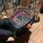 Richard Mille watch side view, red bezel and crown detail, skeleton dial, black case and strap