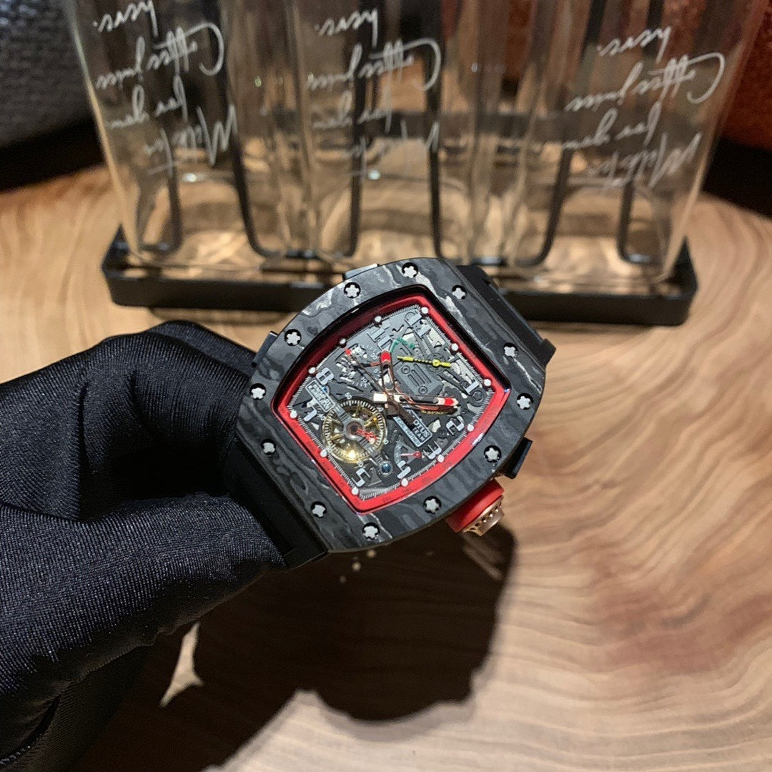Richard Mille watch at angle, red bezel, exposed gears skeleton dial, black strap