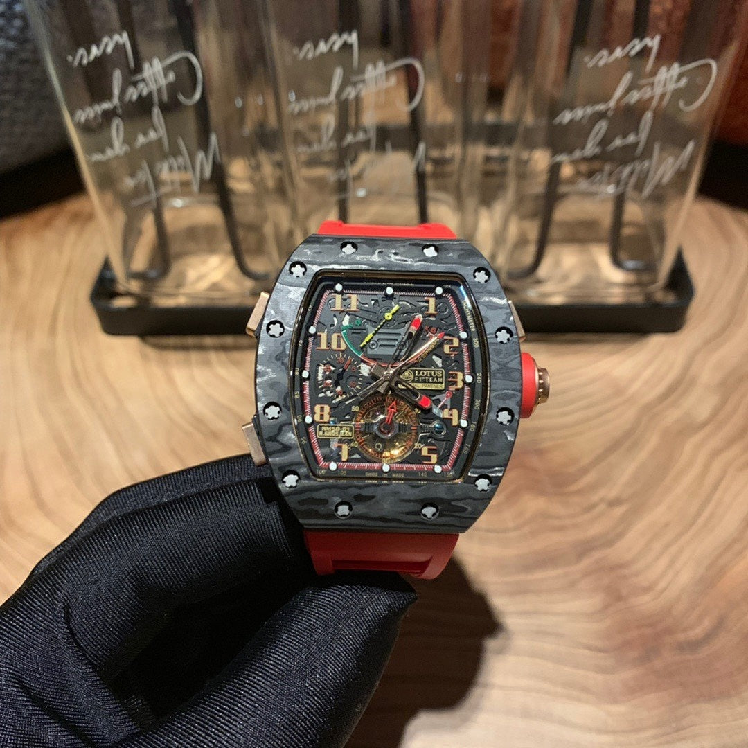 Richard Mille watch with black skeleton dial, octagonal bezel, and red strap on a hand