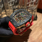 Richard Mille watch close-up, black dial with multicolor details, red strap and crown