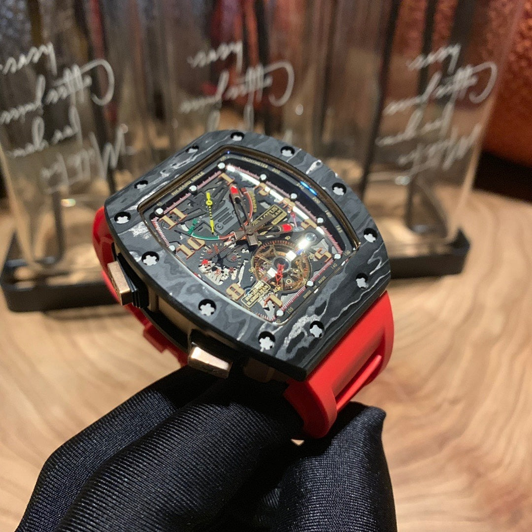Richard Mille watch front angle, black skeleton dial and red strap on glove