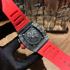 Richard Mille watch case back, black surface and red strap on glove