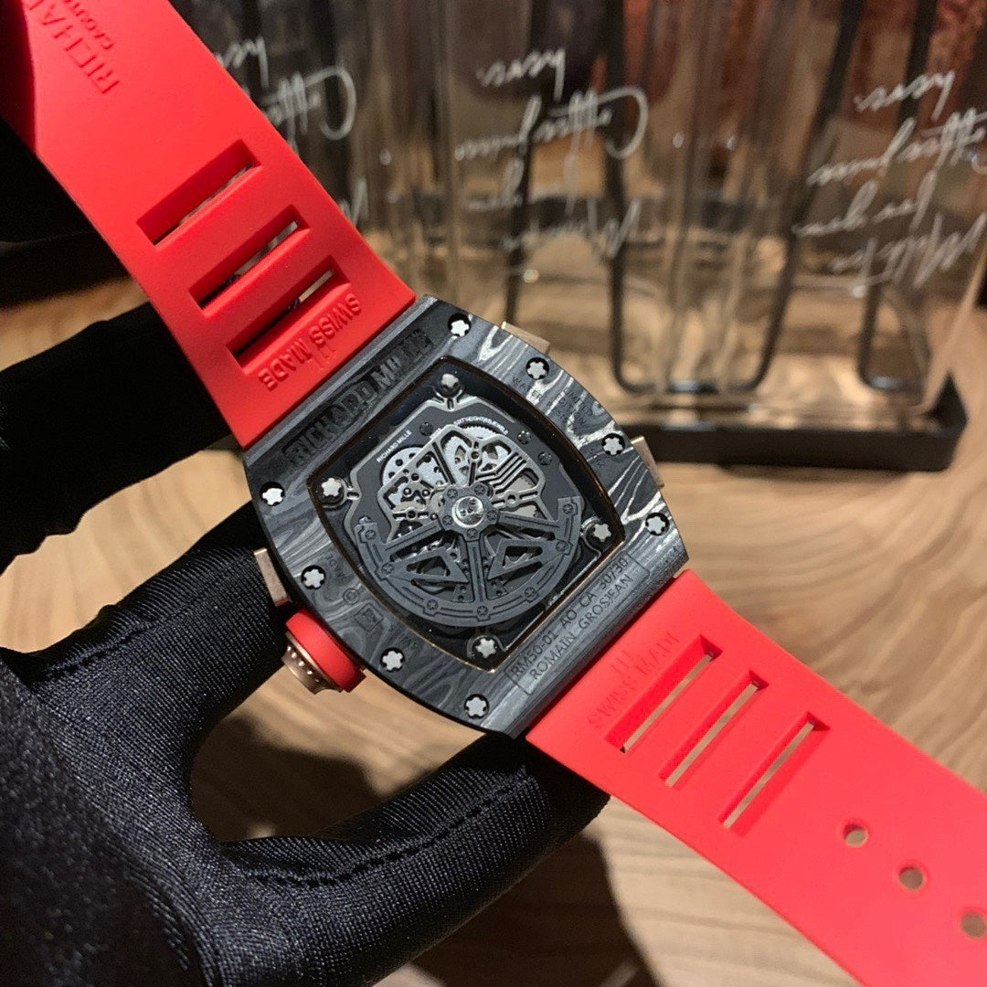 Richard Mille watch case back, black surface and red strap on glove