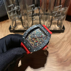 Richard Mille watch side angle, black skeleton dial and red strap on display glove