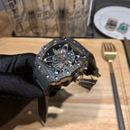Octagonal skeleton watch with black strap and blue open dial, detailed exposed gears