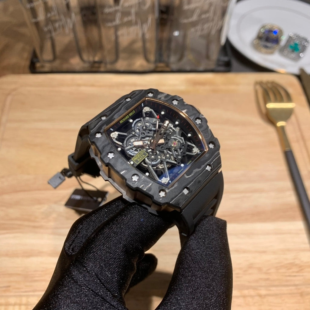 Black rubber-strapped skeleton watch with octagonal case and blue dial, visible mechanics